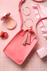 Wall Mural - Stylish bag and different accessories on pink tile background