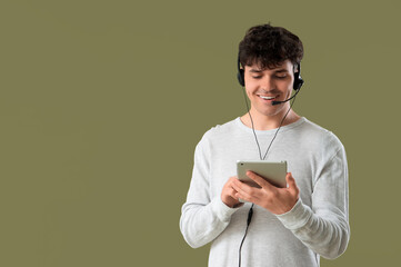 Wall Mural - Male technical support agent with tablet computer on color background