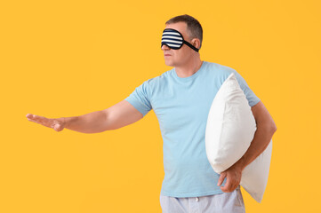 Sticker - Mature man with sleeping mask and soft pillow on yellow background