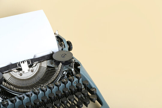 Vintage typewriter on beige background