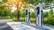 © TEERAWAT - Two electric vehicle charging stations in a green park setting, illuminated by sunlight, promoting sustainable transportation.