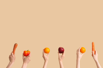 Canvas Print - Hands with fresh fruits and vegetables on beige background