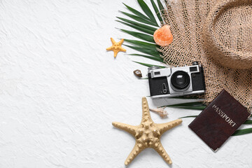 Wall Mural - Beautiful composition with hat, starfishes, passport and photo camera on white grunge background