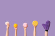 © Pixel-Shot - Female hands with massage glove and bath sponges on purple background