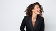 © Iona - confident woman in a sleek black suit laughs joyfully, capturing a moment of pure happiness and professional poise