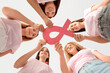 © Pixel-Shot - Beautiful women with pink ribbon on color background, bottom view. Breast cancer awareness concept