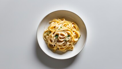 Wall Mural - Top view of a plate of fettuccine alfredo with creamy sauce, isolated on white background.