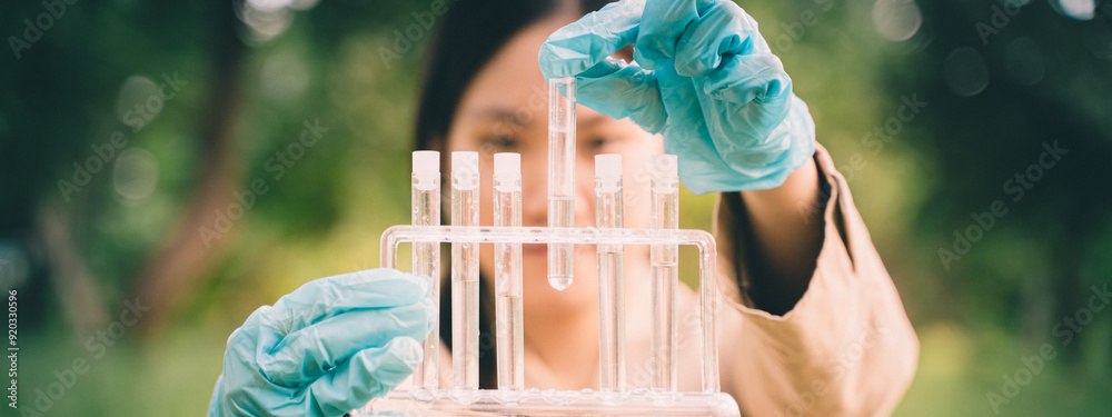 The woman conducted outdoor biology research, using a test tube in the ...