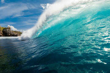 Crashing blue wave in ocean. Wave wall with sun light in Bali