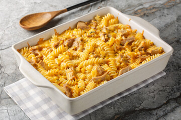 Wall Mural - Tuna Mornay Creamy Tuna Casserole Fussili Pasta Bake  closeup on the baking dish on the table. Horizontal