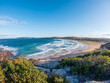 © nomadkate - South Curl Curl Beach in Sydney showcases a panoramic coastline with Sydney Cityscape on the background, a popular destination on the Northern Beaches, Australia