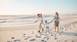© peopleimages.com - Beach, sunset and family with children on sand for outdoor adventure, holiday and weekend trip. Happy, mother and father with kids by ocean in summer for travel, journey and vacation in Florida