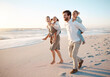 © peopleimages.com - Happy, family and piggyback with children at beach for outdoor adventure, vacation and weekend trip. Sunset, father and mother with kids by ocean in summer for fun holiday, love and travel in Florida