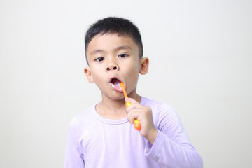 Wall Mural - child Asia kid boy brushing teeth isolated on white backgroud.