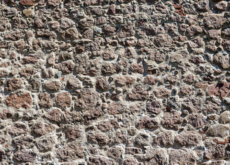 Wall Mural - Texture of an old antique stone wall. Background for design.