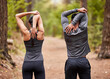 © Lumeez23/peopleimages.com - Back, fitness and stretching with couple in forest for start of marathon, training or workout. Exercise, health and warm up with athlete or runner people in nature for cardio preparation together