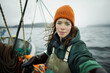 © Ungrim - A female fisherwoman on a boat prepares to work on catching fish