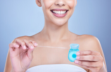 Canvas Print - Dental floss, smile or hands of woman in studio on blue background for cleaning or oral hygiene. String closeup, dentistry or model with product for tooth care to prevent cavity, decay or gum disease