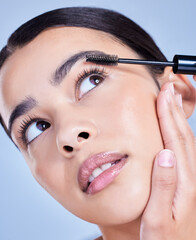 Canvas Print - Woman, thinking and mascara brush in studio for eyelash treatment, application and blue background. Female person, cosmetic tool and skincare for makeup product, cosmetics and hydration for lashes