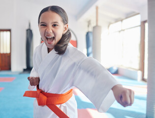 Canvas Print - Martial arts, karate and girl in studio for fitness, training and fight with orange belt, shout or energy. Student, kung fu and practice in dojo as workout for self defense, tai chi and taekwondo