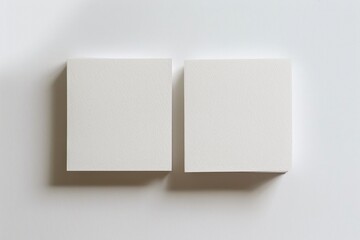 two square blank Business card on white background top view