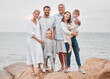© peopleimages.com - Family, portrait and beach for bonding, vacation and travel together in Santorini with generations. People, love and adventure outdoor for relationship, holiday and happiness on rocks with smile