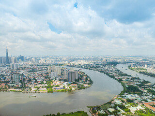 Wall Mural - Panoramic view of Saigon, Vietnam from above at Ho Chi Minh City's central business district. Cityscape with Landmark 81 skyscraper and many buildings, local houses, rivers.