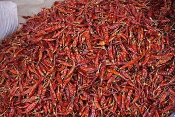 A heap of dry red chili pepper is displayed in a spice market, Dried spicy red chilies are on sale, Showcase of spicy red chili in a spice shop in Asia for the spice trade