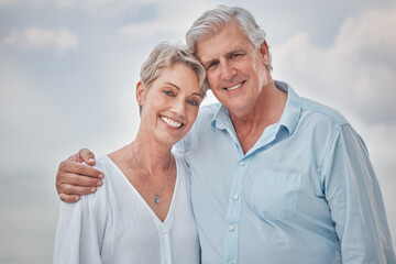 Canvas Print - Portrait, hug and outdoor with senior couple, smile and retirement with happiness, joyful and love. Face, people and man with woman, marriage and relationship with romance, coast and weekend break