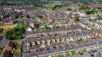 Wall Mural - Aerial drone footage of the British town of Harrogate in North Yorkshire England which is east of the Yorkshire Dales in the summer time showing streets of residential housing estates from above