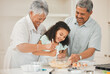 © peopleimages.com - Teaching, child and grandparents with baking in kitchen for helping, mixing and learning cake recipe in home. Family, senior people and girl kid with raw ingredients for cooking education and support
