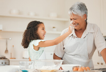 Poster - Baking, playful and child with grandma with flour for cake, cupcakes and dessert in kitchen. Family, home and happy grandmother and girl with ingredients, recipe and food for bonding and learning