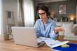 © Srdjan - Pensive young businesswoman look laptop screen work online home office think of problem solution Thoughtful millennial business female unmotivated for computer job Laziness concept lack of motivation.