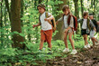 © standret - Adventure time. Kids in forest at summer daytime together