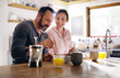 © ReeseBuyout1/peopleimages.com - Happy couple, cereal or eating breakfast with love, diet or juice in morning meal in home kitchen. Romantic people, trust or snack in bowl for bonding, support or food in healthy marriage for care