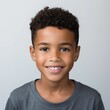 © Lui Shtein - portrait of a cute smiling african american boy wearing a shirt. emotional portrait. on a white background