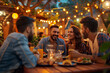© Patcharaphon - Group of friends enjoy having dinner at outdoors restaurant. Meeting, party, celebrate concept