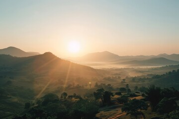Poster - The sun rises over distant mountains, casting a glow across a hazy sky and creating a dreamy, ethereal landscape filled with a tranquil and uplifting ambiance.