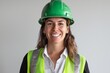 © ChaoticMind - A woman in a green helmet and reflective vest smiles broadly, captured in a construction or industrial environment showcasing her readiness and positive outlook towards her work responsibilities.