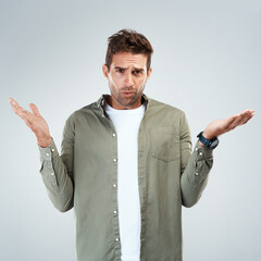 Aufkleber - Man, portrait and confused by choice, option or decision in gray background with hand gesture in studio. Male person, doubt and thinking as frustrated consumer or target audience for product or sale