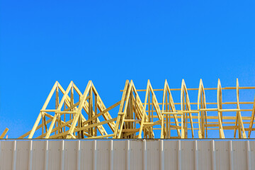 Wall Mural - Wooden roofing truss is framing beam installed on roof of house under construction