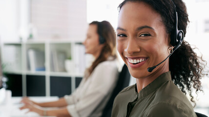 Canvas Print - Woman, portrait and happy in call center for customer service, telemarketing and FAQ in office. Female consultant, smile and headset at desk with team, communication and technical support with tech