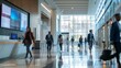 © COK House - A bustling lobby scene with people moving around, some carrying luggage, in a bright space with a screen showing slides.