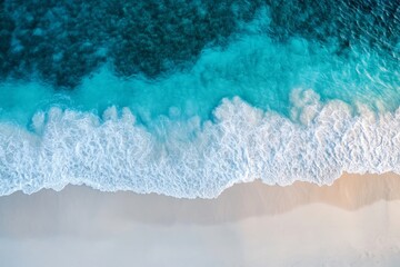 Wall Mural - Turquoise waves crash onto a pristine white sand beach, creating a stunning contrast against the clear blue sky in TobOS