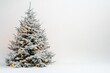 © Anton - Snow-covered Christmas tree with warm lights, minimalistic style