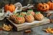 © Maryam - Homemade Halloween holiday treats for kids. Gingerbread cookies on a wooden board, decorated with pumpkins and autumn leaves. Cozy fall home atmosphere, banner