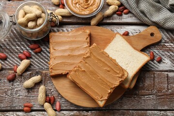 Canvas Print - Delicious sandwiches with peanut butter and fresh nuts on wooden table, flat lay