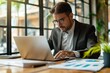 © Road Red Runner - The businessman diligently types on his laptop, planning strategies in a stylish office filled with natural light.