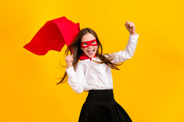 Poster - Photo of cute super girl raise fists shout yes wear uniform isolated on yellow color background