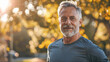 © Kowit - Serene Morning Fitness Routine Mature Man Exercising in Park Under Summer Light with Joyful Expression